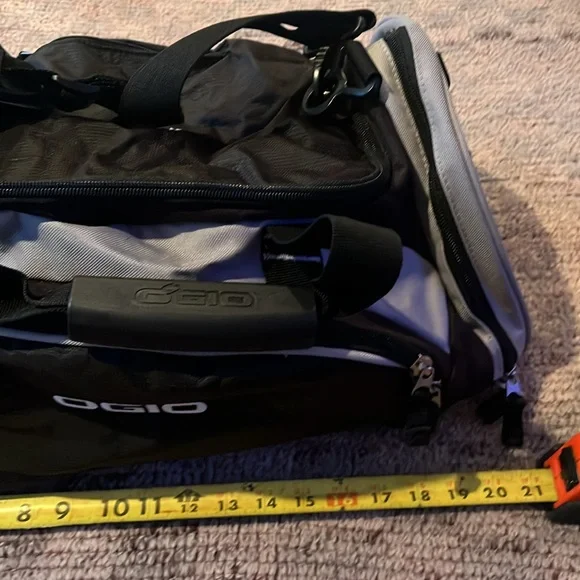 New OGIO sports illustrated black and gray duffle bag with shoulder strap.